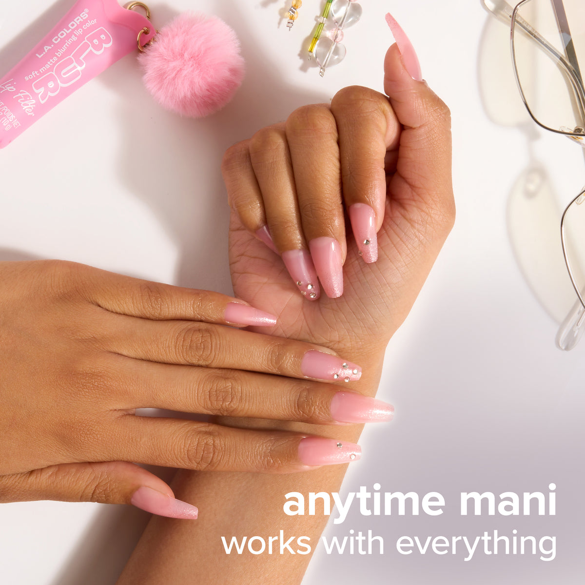 Thumbnail: Anytime mani that works with everything: pink gem-detail Glam Mani nails shown with glasses and a pom keychain.