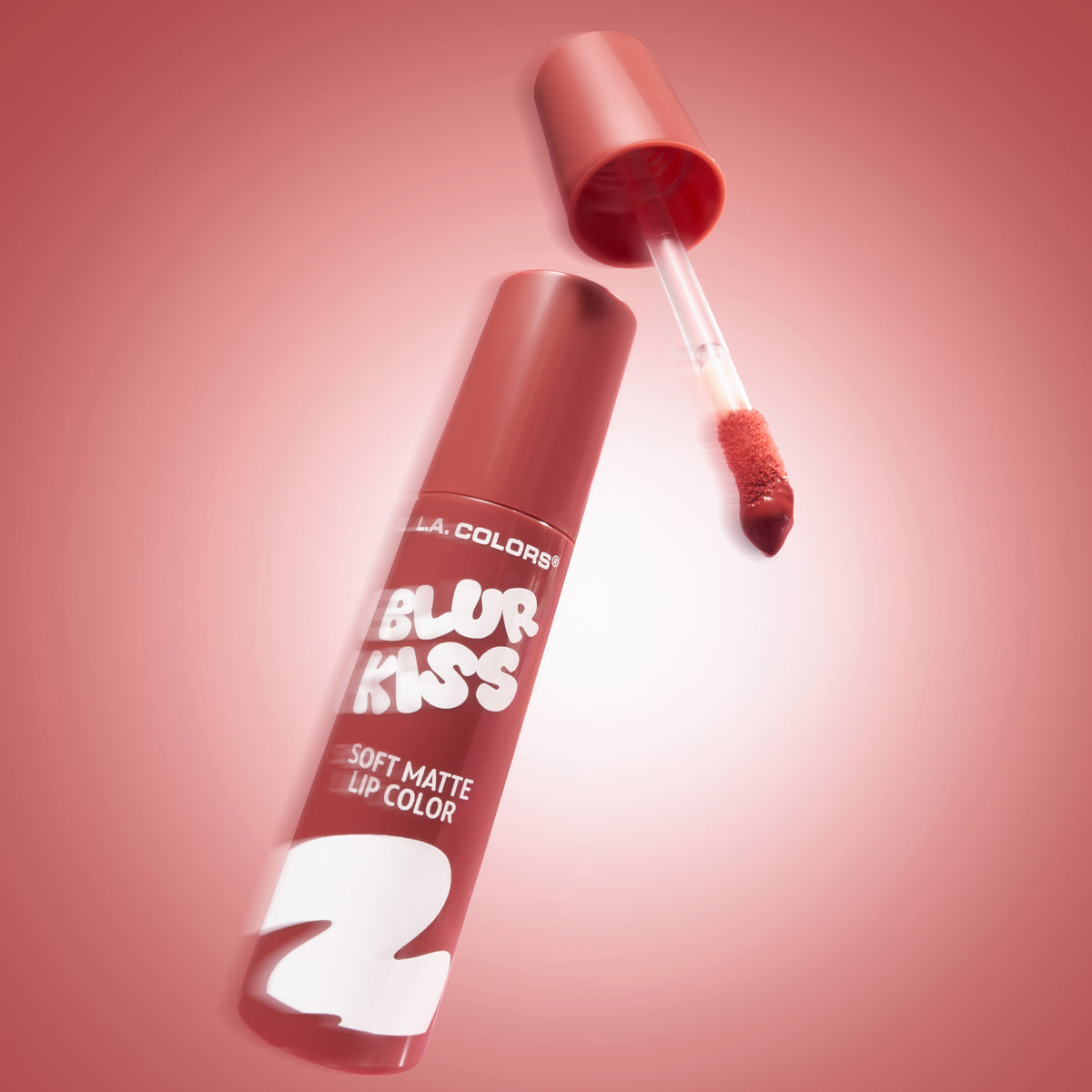 L.A. Colors Blur Kiss Soft Matte Lip Color in Sweet Rush, open tube and applicator on a pink background.