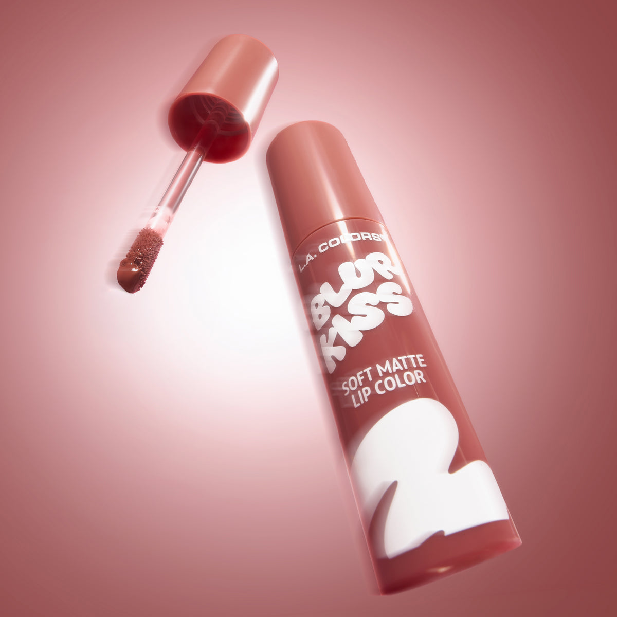 Thumbnail: L.A. Colors Blur Kiss Soft Matte Lip Color in Plush Blush, open tube and applicator on a pink background.