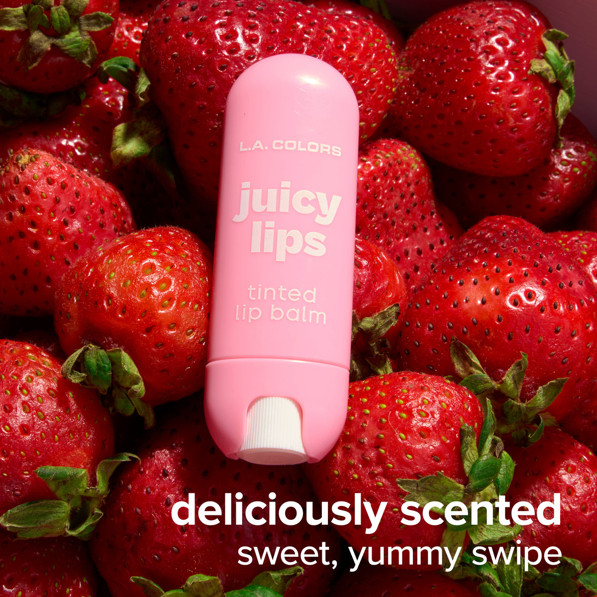 Thumbnail: Juicy Lips Tinted Lip Balm in Pucker Up surrounded by strawberries