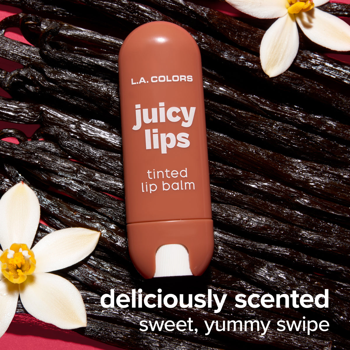 Juicy Lips Tinted Lip Balm in Vanilla Bean displayed over vanilla beans and flowers