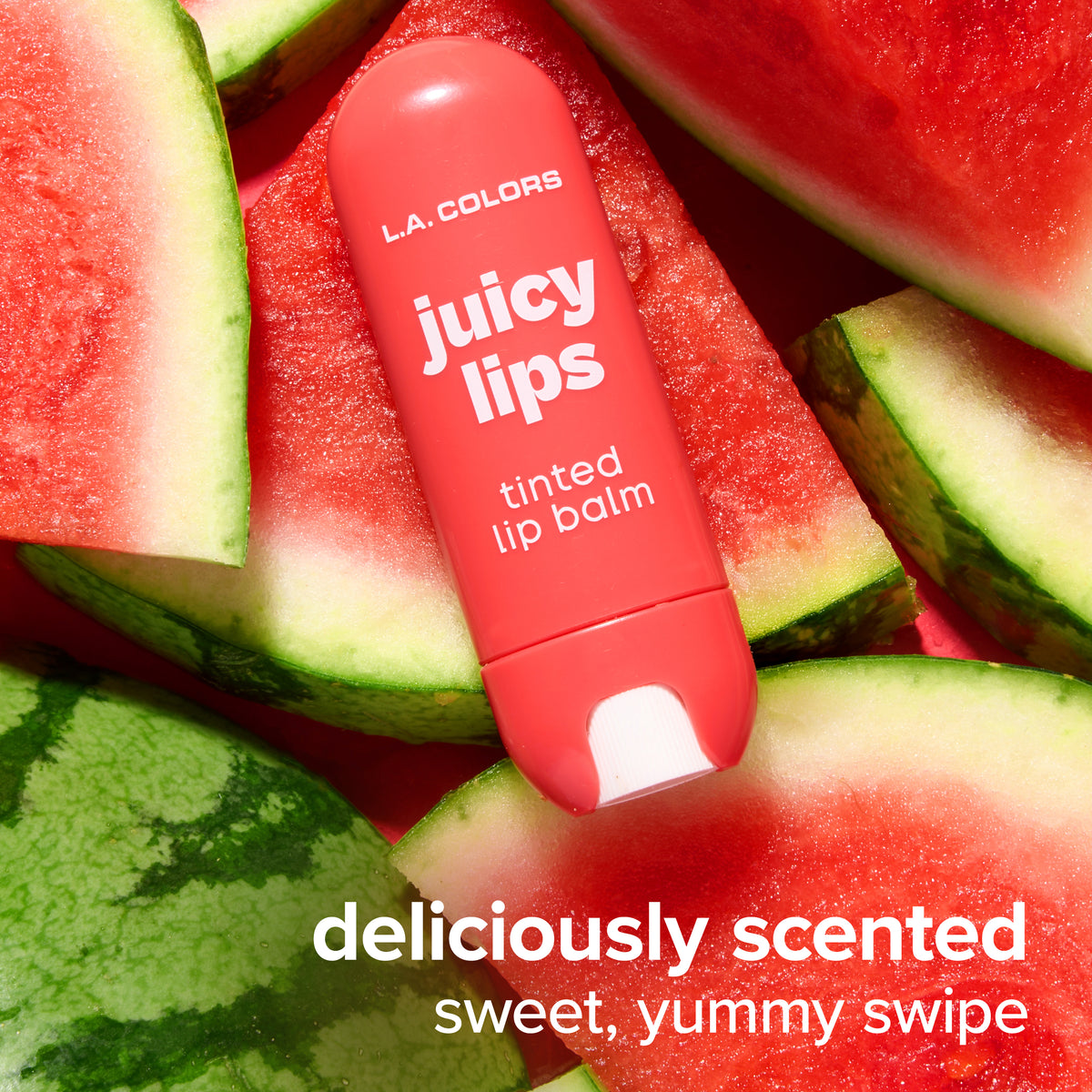 Thumbnail: Juicy Lips Tinted Lip Balm in Rosy Melon surrounded by watermelon slices