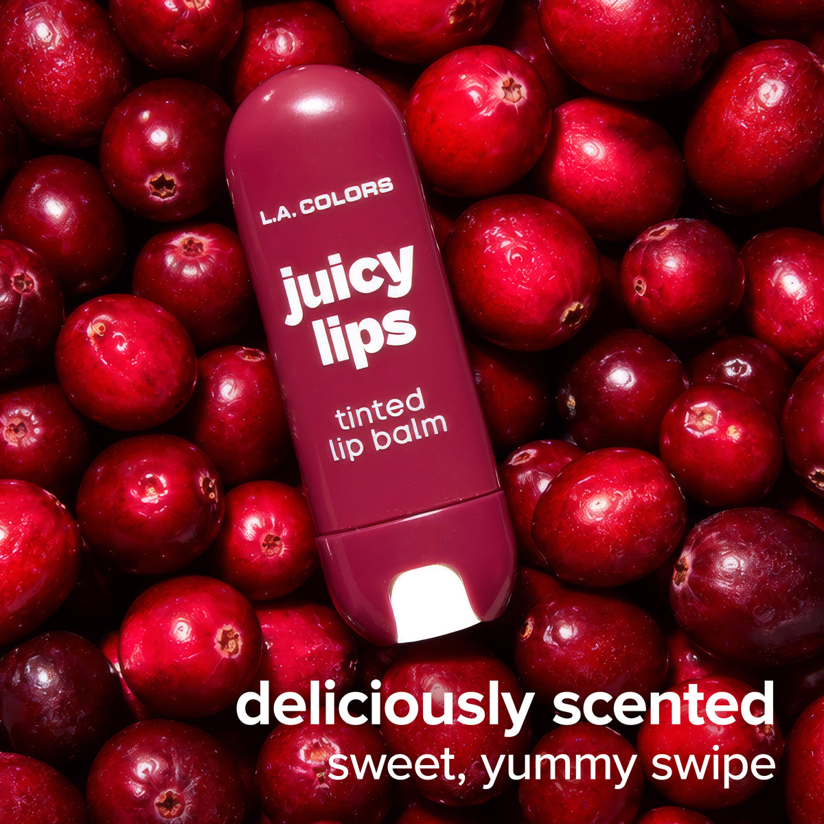 Juicy Lips Tinted Lip Balm in Cran Craze surrounded by fresh cranberries