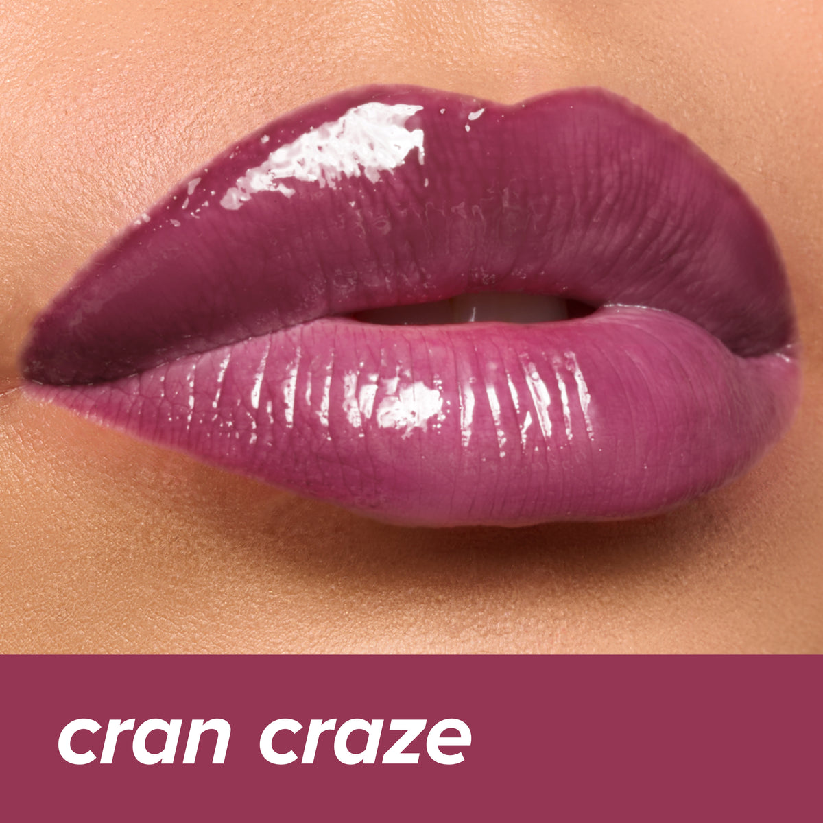 Thumbnail: Juicy Lips Tinted Lip Balm in Cran Craze — deep berry-mauve glossy finish on lips