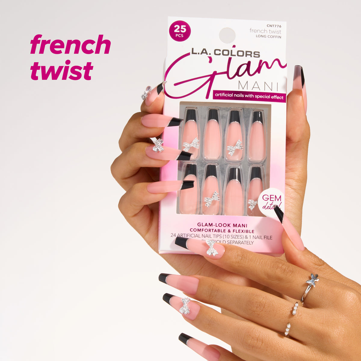 L.A. Colors Glam Mani Nail Tips in French Twist (CNT776): long coffin French tips with bow gem detail, 25-piece pack held in hand.
