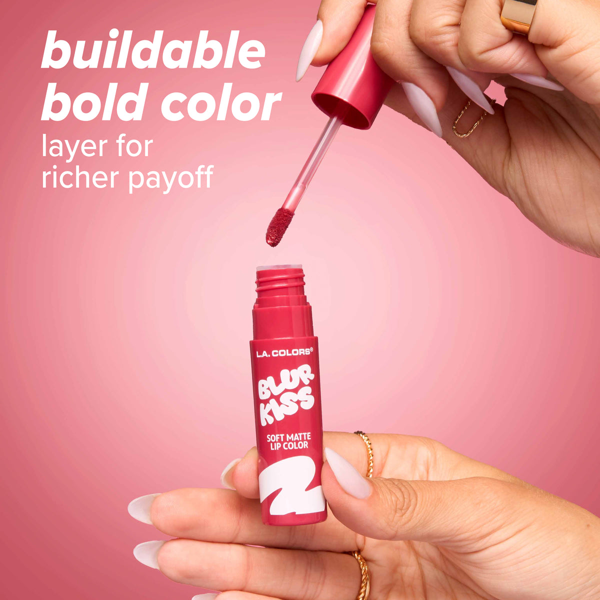 Thumbnail: Hand lifting the applicator out of an open tube of L.A. Colors Blur Kiss Soft Matte Lip Color. Text: buildable bold color, layer for richer payoff.