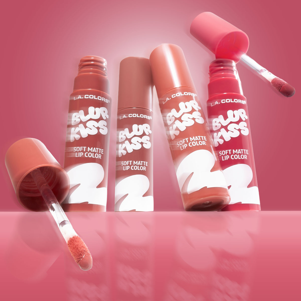 Thumbnail: Four open tubes of L.A. Colors Blur Kiss Soft Matte Lip Color with their applicators on a pink background.